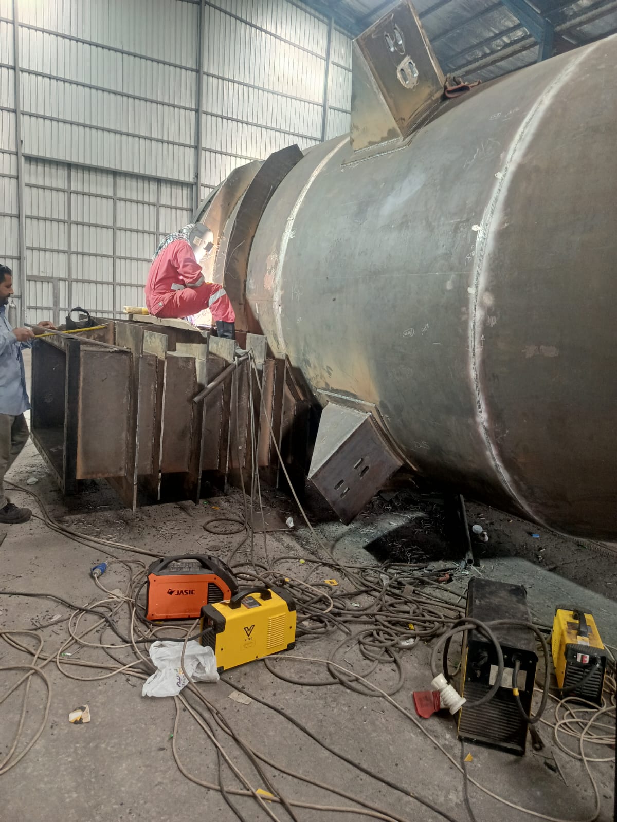 Welder working on a large industrial vessel