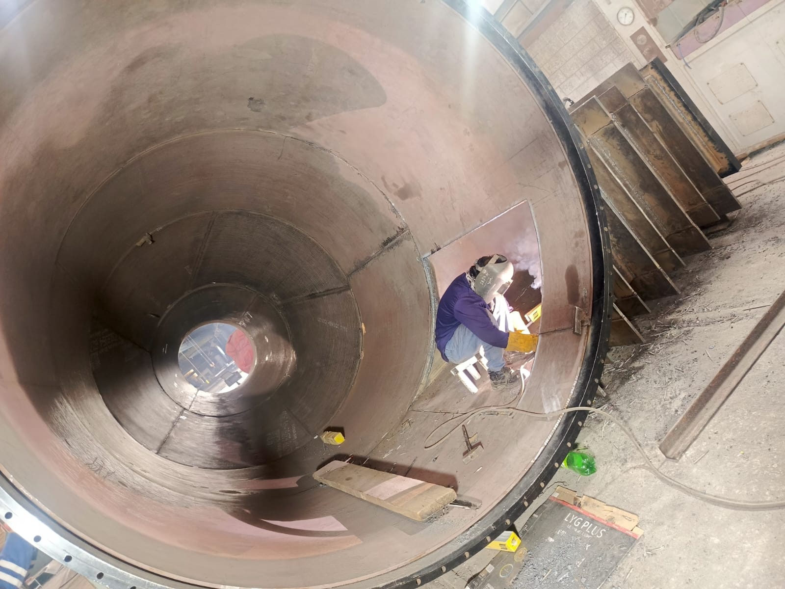 Welder completing internal vessel fabrication