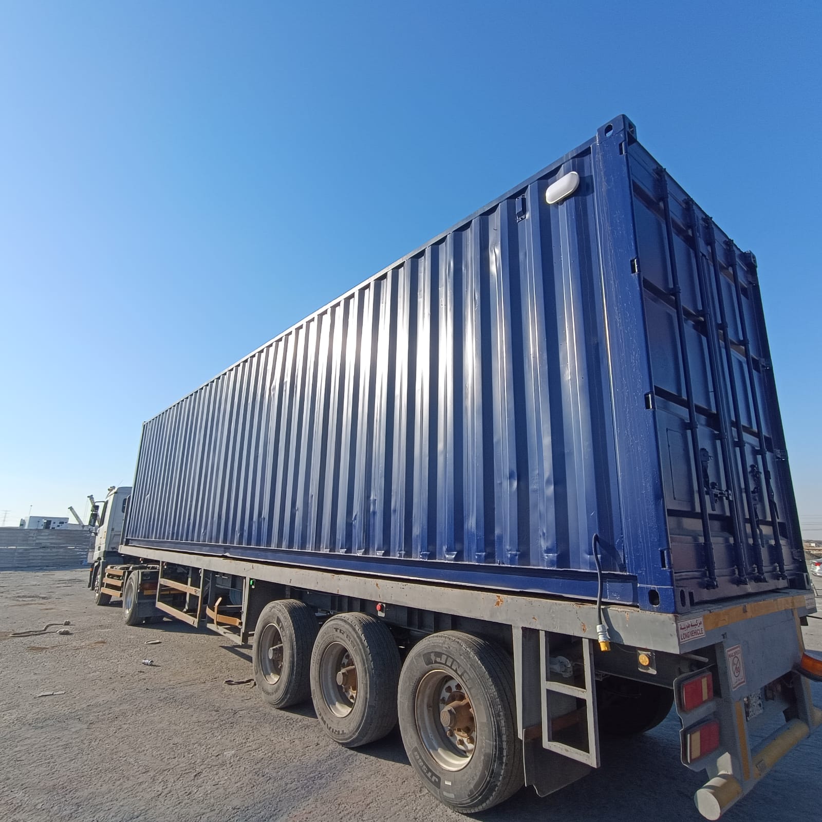 Fabricated industrial container module on a transport trailer