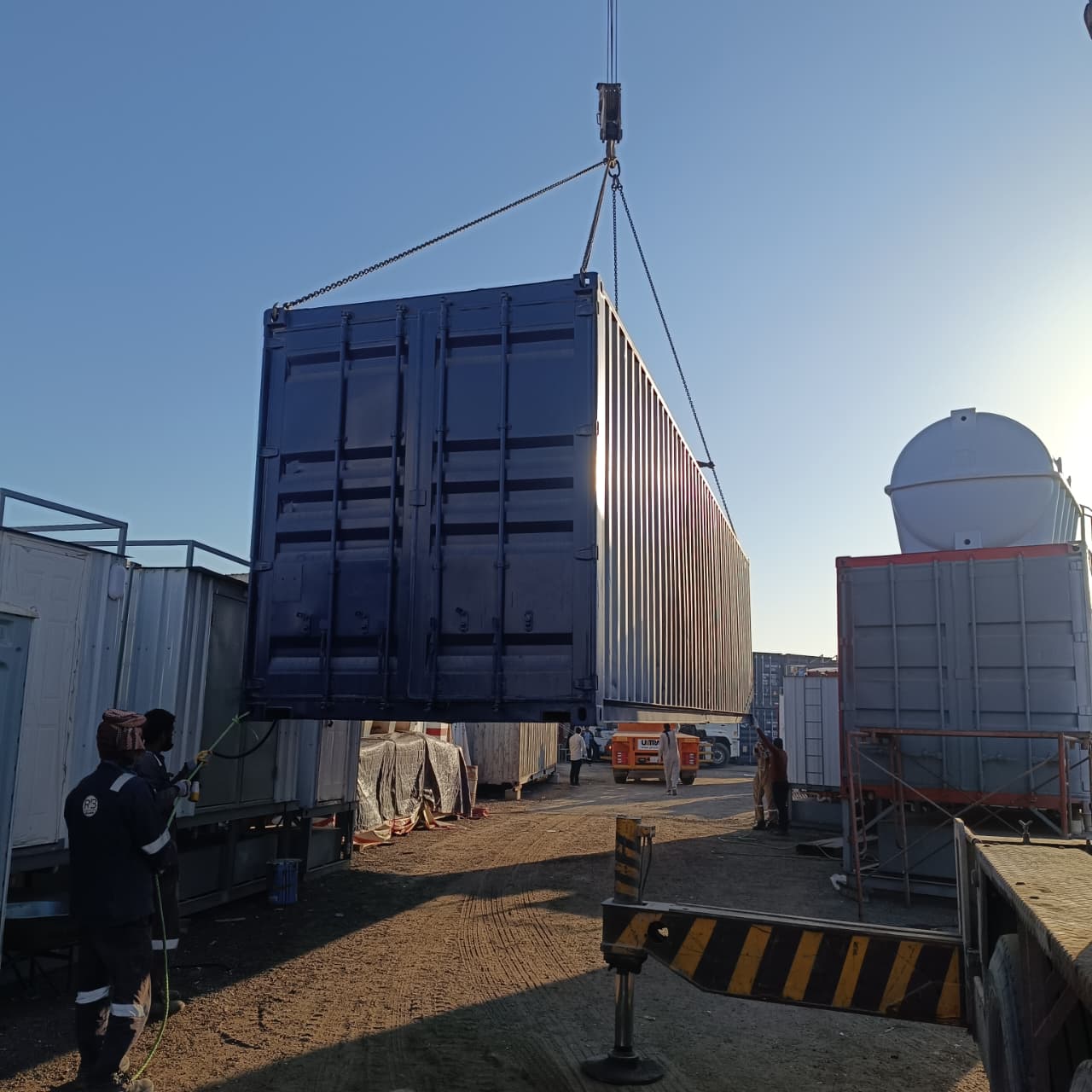 Crane lifting a completed modular container