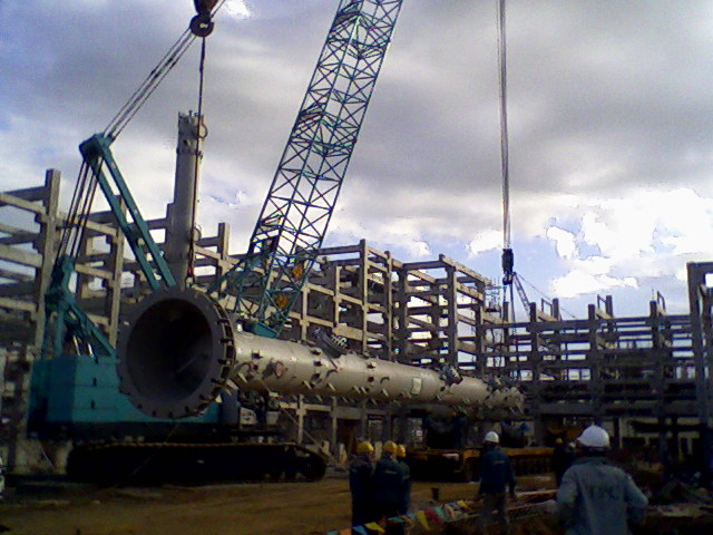 Crane lifting a process column for installation
